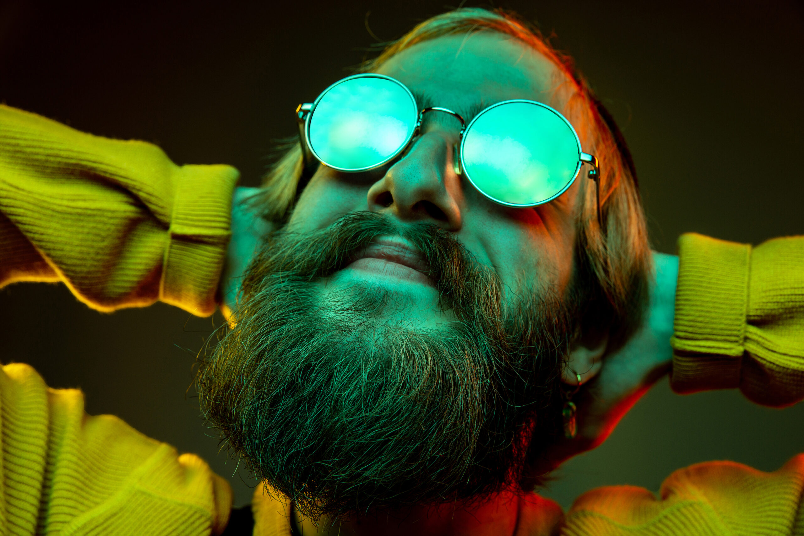 Caucasian man's portrait isolated on gradient studio background in neon light